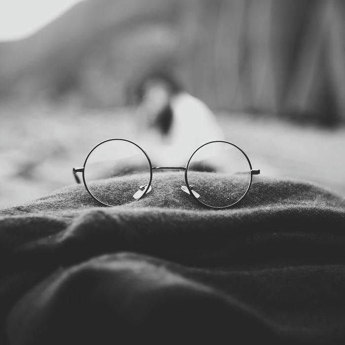 Hình nền đen kính mắt tròn đặt trên vải mềm mại